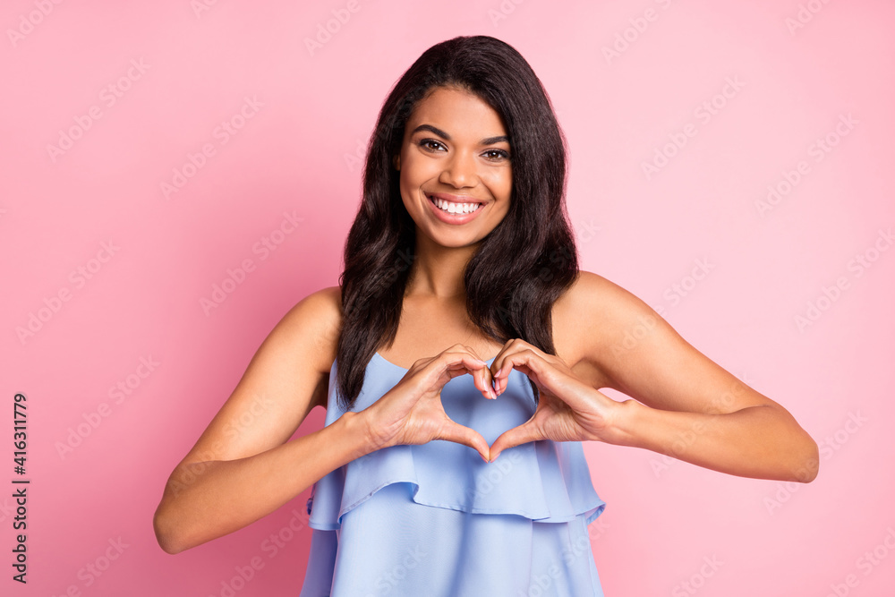 Photo of optimistic brunette lady show heart wear blue top isolated on pastel pink color background Photo of optimistic brunette lady show heart wear blue top isolated on pastel pink color background