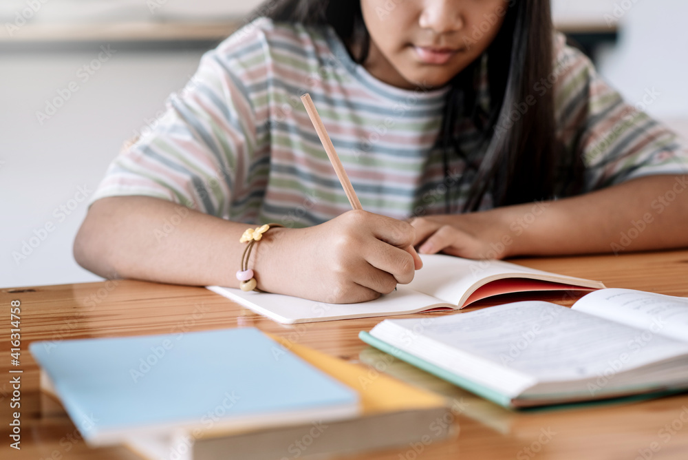 Close up of a woman hand taking notes at home.