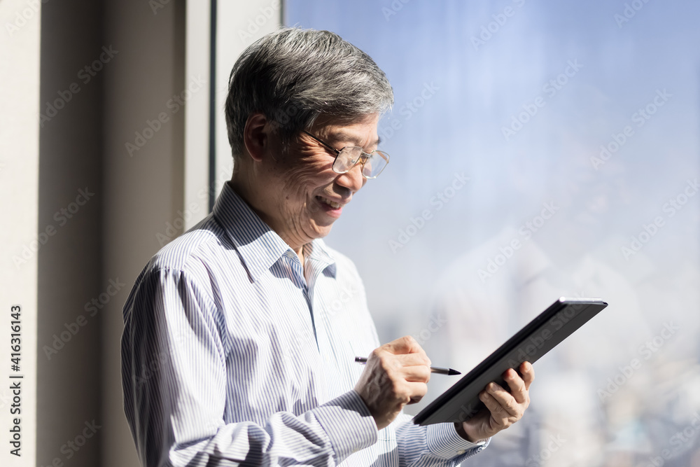 man use tablet near window man use tablet near window