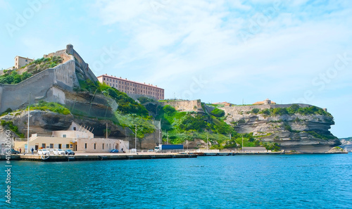 The Citadel walls of Bonifacio from its harbor, Corsica, France photo