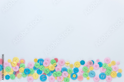 Colorful buttons on a white background. A place for text. Green, blue, yellow, pink buttons.