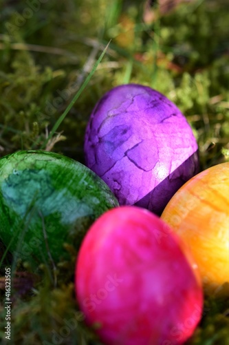 Close up of colorful eastereggs in the mossy grass