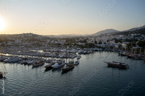 Aerial view of marina harbor in Bodrum, Turkey. Ships and yachts in the port at sunset. Summer vacation concept. © DenisProduction.com