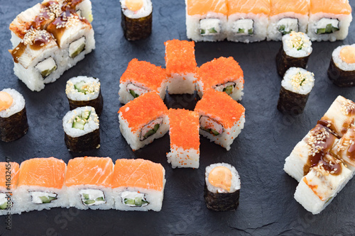 Assorted from the roll. Japanese cuisine. rolls on a stone platter. serving the table.