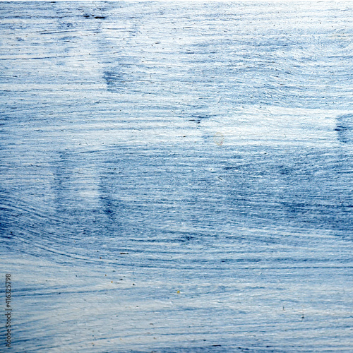 Blue grey wooden background with white stains of acrylic paint