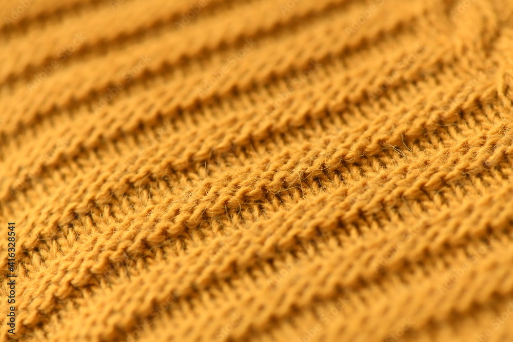 Mustard knitted blanket Knitting by hand. Background orange colour of wool.