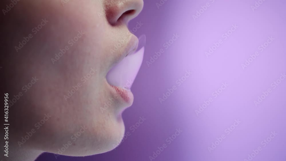 Young Woman Female Smoker Smoking E-Cigarette in studio. Young Woman Female Smoker Smoking E-Cigarette in studio.