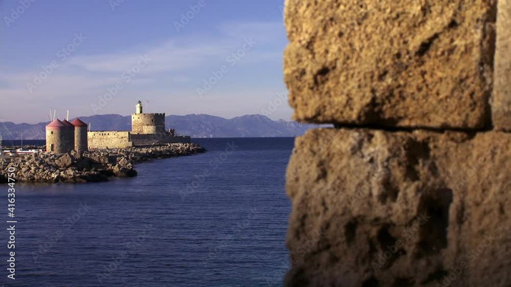 Rhodes Greece the lighthouse of Agios Nikolaos at the entrance of the port of the island and the old medieval walls