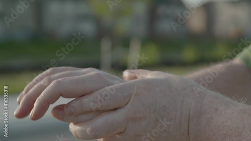 Close up of rubbing sanitizer gel on hands photo