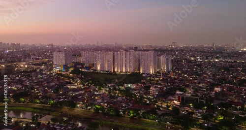 Aerial Night View Timelapse jakarta city and apartment blocks from suburban east jakarta