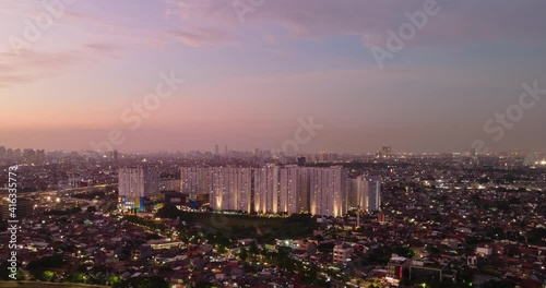 Aerial Night View Timelapse jakarta city and apartment buildings from suburban east jakarta