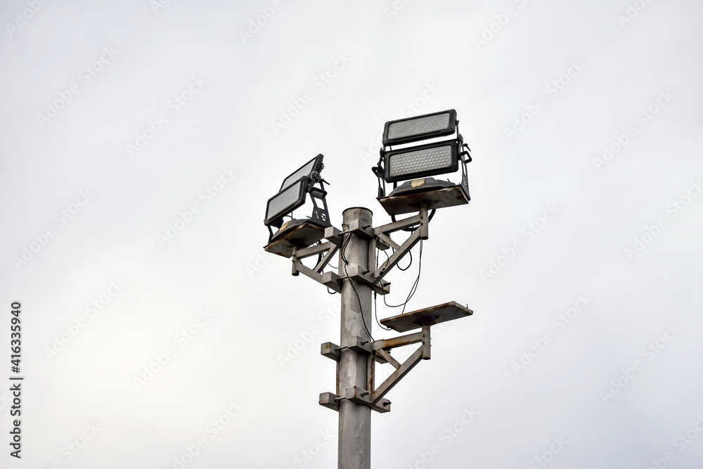 An energy efficient LED street light stands against an empty sky. An energy efficient LED street light stands against an empty sky.