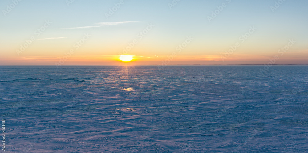 sunset over the frozen north sea