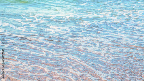 crystal clear azure water with sea foam  seascape background