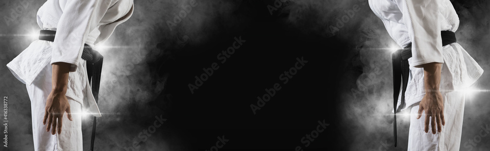Fototapeta premium Martial arts masters on dark smoke background