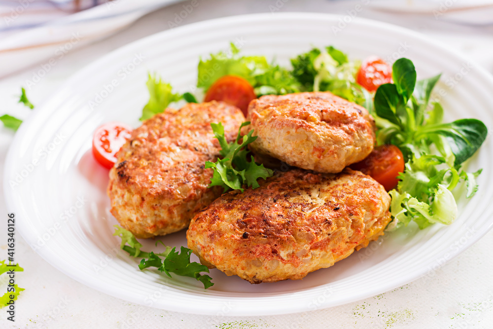 Meatballs with cabbage. Lazy cabbage rolls with fresh salad on light background. Russian cuisine.