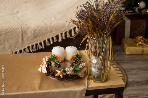 New Year's composition on the table. Cones, candles, spruce branches, bouquet