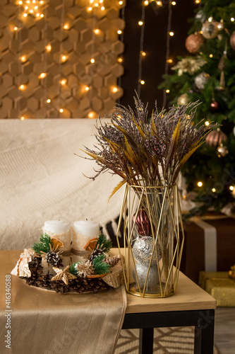 New Year's composition on the table. Cones, candles, spruce branches, bouquet