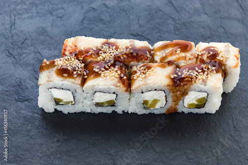 rolls with teriyaki sauce. Rolls and sushi. Avocado, rice, eel. Eel rolls. serving a dish