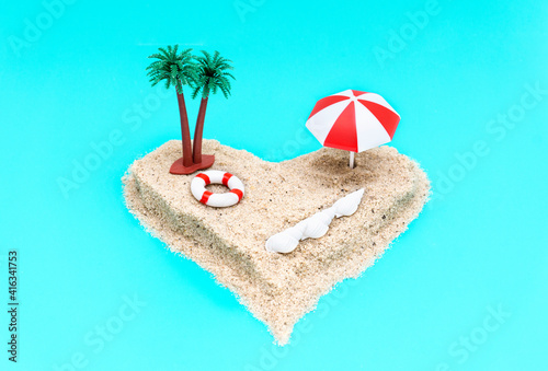 Angle view of a heart-shaped miniature toy island set-up. Vacation concept.