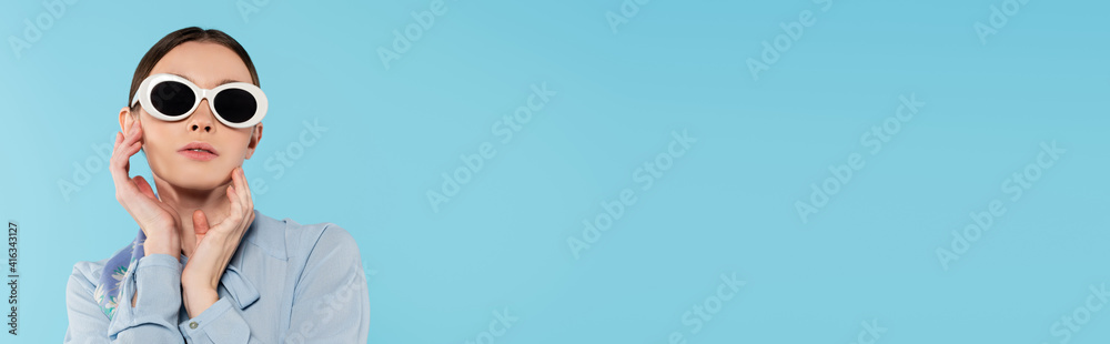 glamour woman in sunglasses posing with hands near face isolated on blue, banner glamour woman in sunglasses posing with hands near face isolated on blue, banner