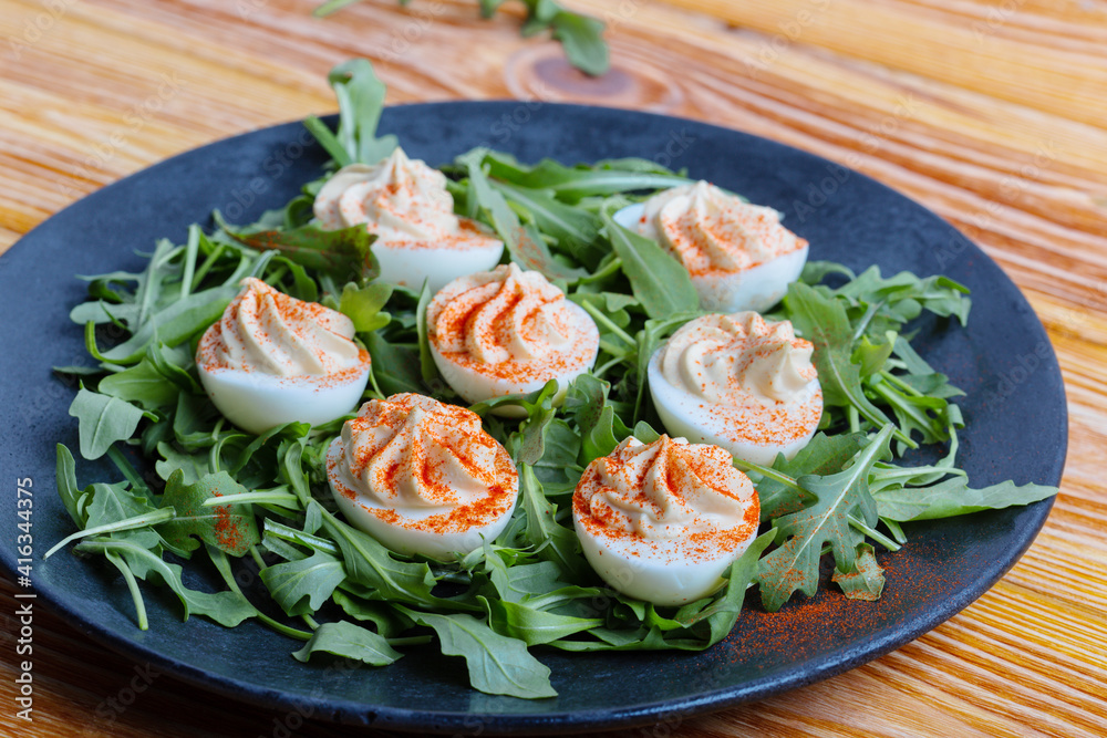 Keto deviled eggs with creamy filling and smoked paprika