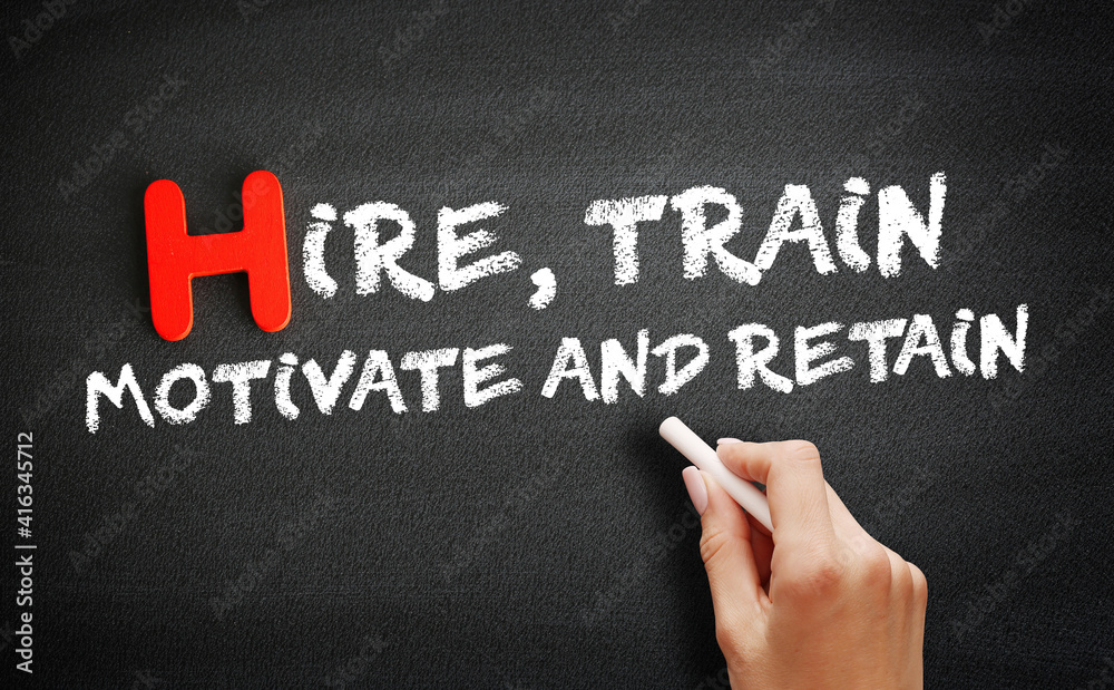 Hire, Train, Motivate and Retain text on blackboard, concept background Hire, Train, Motivate and Retain text on blackboard, concept background