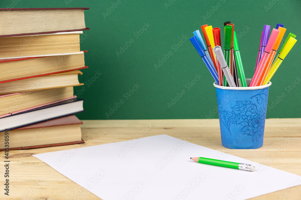a sheet of white paper and a pencil on a green background a sheet of white paper and a pencil on a green background