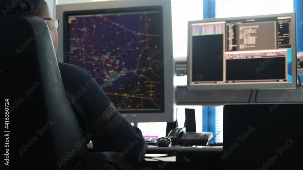 Navigation control room in the airport - a person working with a monitor with fly paths placed on the map