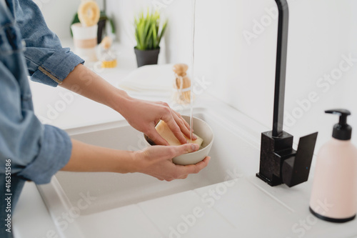 Woman washing dishes in the kitchen.