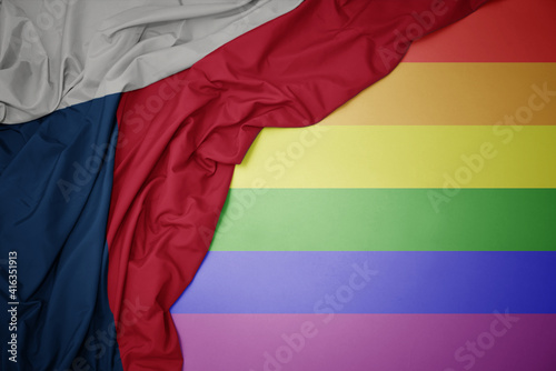 waving national flag of czech republic on a gay rainbow flag background.