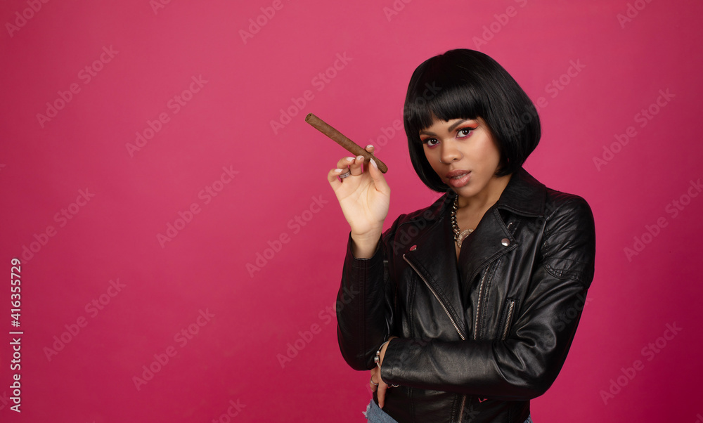 A creative portrait of a beautiful black sexy woman in leather smoking cigar. A creative portrait of a beautiful black sexy woman in leather smoking cigar.