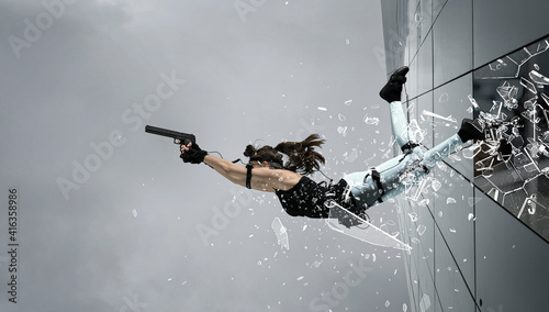 Woman playing on the simulator, holding gun.   Blockbuster, action movie photo