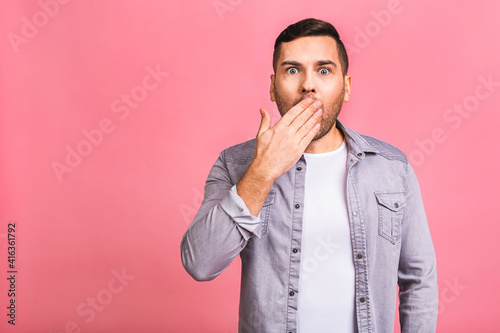 Horizontal shot of stupefied stunned shocked young male man keeps mouth widely opened, being surprised, expresses great surprisment. Isolated over pink background.