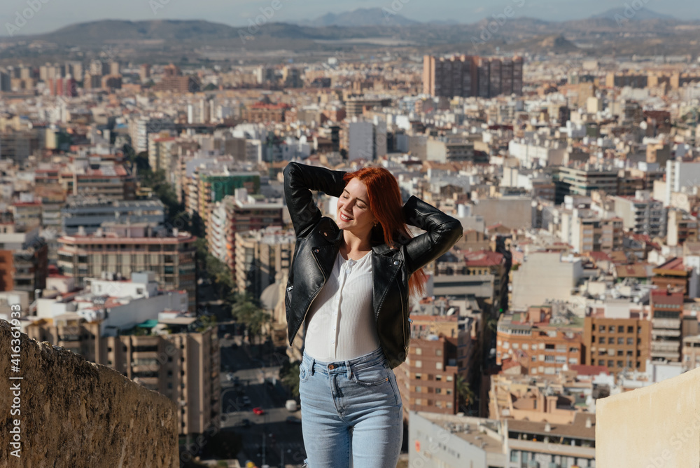 beautiful Happy Woman enjoys the views of the City