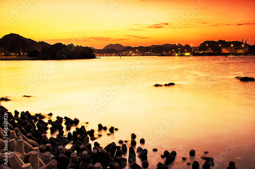 Sunset at a lake with mountains in the background 
