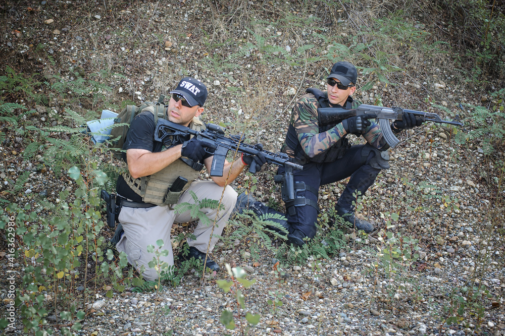 Army soldiers shooting with rifle machine gun in the forest. Nature outdoor military combat training Army soldiers shooting with rifle machine gun in the forest. Nature outdoor military combat training