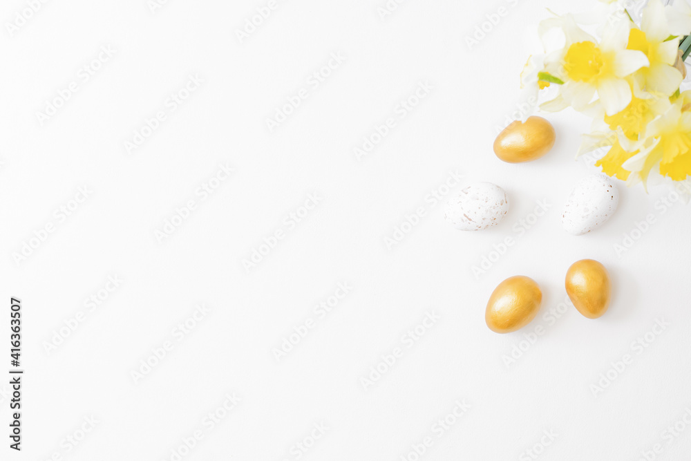 Flat lay easter composition with daffodils in a vase and eggs on white background Flat lay easter composition with daffodils in a vase and eggs on white background