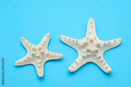  Travel background. Starfishes on a blue background