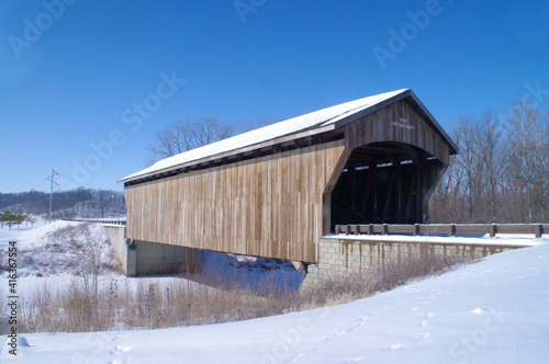 Wooden covered bridge in snow