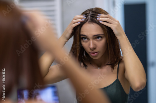 Young Woman taking care of her skin in bathroom