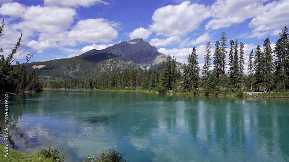 Town of Banff, Bow River Trail scenery in summer sunny day. Banff National Park, Canadian Rockies, Alberta, Canada. Cascade Mountain in the background. Town of Banff, Bow River Trail scenery in summer sunny day. Banff National Park, Canadian Rockies, Alberta, Canada. Cascade Mountain in the background.