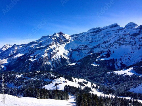 Beautiful Shot Across Snowy Valley, Trees and Mountains With Ski Lift and Chalet, Villars, Ollon