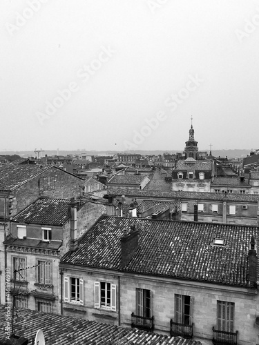 Dramatic Black and White Shot of Bordeaux Rooftops and Church Against a Grey Sky