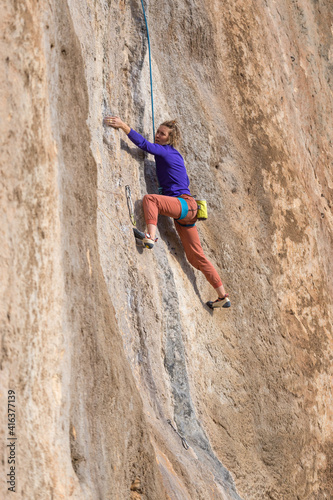 girl climbs a rock-climbing route. outdoor sports.