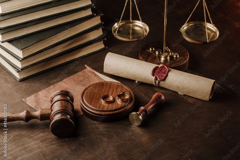 Wooden judge gavel and golden rings. Divorce concept.