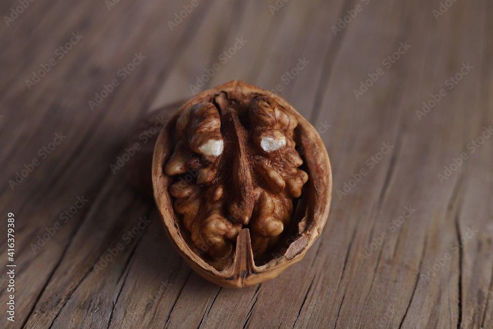 relief walnut with an unusual shape on a wooden board relief walnut with an unusual shape on a wooden board
