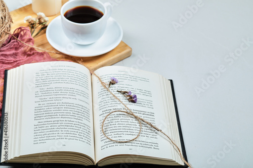 Book with cup of coffee on the wooden board