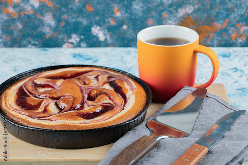 Strawberry syrup pie served with a cup of tea photo