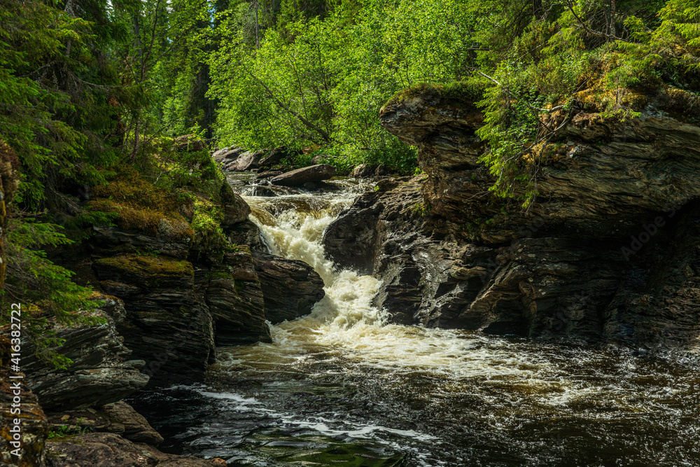 Creek in northern Sweden flushing through eroded rocks